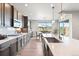 Bright open kitchen with stainless steel appliances, large center island, and backyard views at 7950 Piney River Ave, Littleton, CO 80125