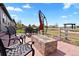Inviting patio with outdoor seating, a stylish fire pit and an umbrella for relaxation at 7950 Piney River Ave, Littleton, CO 80125