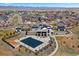 Aerial view of the community pool and clubhouse surrounded by well-manicured landscaping at 7950 Piney River Ave, Littleton, CO 80125