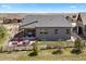 Aerial view of the house showcasing a private patio, fenced yard, and well-maintained landscaping at 7950 Piney River Ave, Littleton, CO 80125