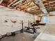 Unfinished basement with exposed ceiling, concrete floor, exercise equipment, and furniture area at 4628 Mt Shavano St, Brighton, CO 80601