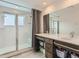 Beautiful bathroom featuring a double vanity, a glass shower, and ample storage space at 4628 Mt Shavano St, Brighton, CO 80601