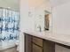 Bright bathroom features a tub with shower and a modern vanity with a large mirror at 4628 Mt Shavano St, Brighton, CO 80601