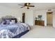 This spacious bedroom features plush carpeting, ceiling fan and walk-in closet at 4628 Mt Shavano St, Brighton, CO 80601