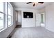 Spacious bedroom with carpet flooring, a ceiling fan, and natural light from the large windows at 4628 Mt Shavano St, Brighton, CO 80601