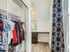 Walk-in closet with built-in shelves and storage for ample wardrobe and organization, window and desk area at 4628 Mt Shavano St, Brighton, CO 80601