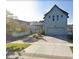 Two-story home features a spacious driveway, attached garage, manicured lawn, and a light-blue exterior at 4628 Mt Shavano St, Brighton, CO 80601