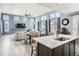 Open-concept kitchen with white countertops, hardwood floors, and an island with bar stool seating at 4628 Mt Shavano St, Brighton, CO 80601