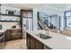 Modern kitchen featuring a quartz island, stainless steel appliances, and wooden cabinetry at 4628 Mt Shavano St, Brighton, CO 80601