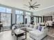 Spacious living room with high ceilings, large windows, hardwood floors, and a comfortable seating area at 4628 Mt Shavano St, Brighton, CO 80601