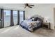 Cozy main bedroom with a large bed, a ceiling fan, and plenty of natural light from the windows at 4628 Mt Shavano St, Brighton, CO 80601