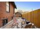 Cozy backyard with a fire pit, comfortable seating, and a charming detached garage in a private setting at 1453 S Lafayette St, Denver, CO 80210