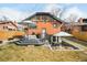 Spacious backyard featuring a deck, patio with seating, lush lawn, and well-maintained landscaping at 1453 S Lafayette St, Denver, CO 80210