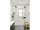 Contemporary shower with black fixtures, subway tile, glass door, and a wooden bench at 1453 S Lafayette St, Denver, CO 80210