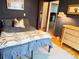 A bedroom with colorful Pendleton-style blankets, blue walls, and light wood floors at 1453 S Lafayette St, Denver, CO 80210