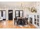 Elegant dining room with a modern chandelier, fireplace, and hardwood floors at 1453 S Lafayette St, Denver, CO 80210
