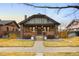 Charming brick home with a well-manicured lawn, inviting front porch, and appealing curb appeal at 1453 S Lafayette St, Denver, CO 80210
