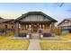 Attractive brick home with a tidy front yard, covered porch, and classic architectural details at 1453 S Lafayette St, Denver, CO 80210