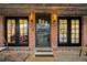 Inviting front porch with black framed glass doors, decorative security door, and stylish sconces at 1453 S Lafayette St, Denver, CO 80210