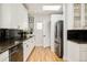 Galley kitchen featuring stainless steel appliances, skylight, and granite counters at 1453 S Lafayette St, Denver, CO 80210