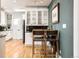 Bright, open kitchen with stainless steel appliances and seating for two at 1453 S Lafayette St, Denver, CO 80210