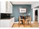 Bright kitchen with a view of adjacent dining area with table and chairs at 1453 S Lafayette St, Denver, CO 80210
