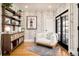 Stylish living room with a cozy chair, built-in shelves, and hardwood floors at 1453 S Lafayette St, Denver, CO 80210