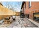 Inviting stone patio with outdoor seating and a charming brick home backdrop, perfect for relaxation at 1453 S Lafayette St, Denver, CO 80210