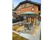 Home's outdoor space with sunken patio and dining under a blue umbrella at 1453 S Lafayette St, Denver, CO 80210