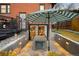 This patio has an outdoor dining area with steps leading to the backyard at 1453 S Lafayette St, Denver, CO 80210