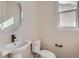 Simple bathroom with a modern sink and faucet, white toilet, and natural light at 2962 Newfound Lake Rd, Berthoud, CO 80513