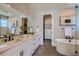 Luxurious bathroom with double vanity, soaking tub, and walk-in closet at 2962 Newfound Lake Rd, Berthoud, CO 80513