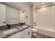 Modern bathroom with double vanity, granite counters, and a shower over tub at 2962 Newfound Lake Rd, Berthoud, CO 80513