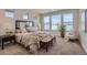 Bright and airy bedroom with large windows, neutral decor, and a cozy seating area at 2962 Newfound Lake Rd, Berthoud, CO 80513