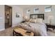 Serene bedroom with neutral tones, a bench at the foot of the bed, and ample natural light at 2962 Newfound Lake Rd, Berthoud, CO 80513