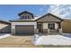 Beautiful two-story home with stone accents, gray trim, a two-car garage, and snow-covered landscaping at 2962 Newfound Lake Rd, Berthoud, CO 80513