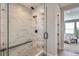 Elegant shower with marble tile, glass enclosure, and modern fixtures at 2962 Newfound Lake Rd, Berthoud, CO 80513