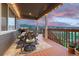 Inviting back porch with string lights, dining set, and a view of the neighborhood and surrounding hills at 6470 Amur Ct, Castle Rock, CO 80108
