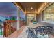 Relaxing back porch with string lights and a metal dining set overlooking the manicured backyard at 6470 Amur Ct, Castle Rock, CO 80108