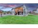 Spacious backyard with a deck, pergola, manicured lawn, and professional landscaping at 6470 Amur Ct, Castle Rock, CO 80108