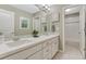 Bright bathroom with double vanity, framed mirrors, and tub/shower combo at 6470 Amur Ct, Castle Rock, CO 80108