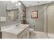 Well lit bathroom with a modern sink, an oval mirror, a toilet, and a glass door shower at 6470 Amur Ct, Castle Rock, CO 80108