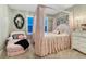 Charming bedroom featuring a four-poster bed, chair and an abundance of natural light at 6470 Amur Ct, Castle Rock, CO 80108