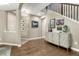 Elegant entryway with hardwood floors, stylish console table, decorative art, and staircase at 6470 Amur Ct, Castle Rock, CO 80108