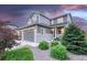 Beautiful two-story home with stone accents, landscaped yard, and attached two-car garage at 6470 Amur Ct, Castle Rock, CO 80108