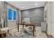 A stylish home office featuring a modern desk, patterned accent wall, and abundant natural light at 6470 Amur Ct, Castle Rock, CO 80108
