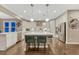 Spacious open kitchen features a large island, stainless steel appliances, and hardwood floors at 6470 Amur Ct, Castle Rock, CO 80108