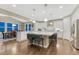 Spacious open kitchen features a large island, stainless steel appliances, and hardwood floors at 6470 Amur Ct, Castle Rock, CO 80108