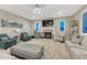 Comfortable living room with plush seating, fireplace, and large windows allowing natural light at 6470 Amur Ct, Castle Rock, CO 80108
