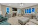 A cozy living room with a fireplace, large windows, comfortable seating, and tasteful decorations at 6470 Amur Ct, Castle Rock, CO 80108